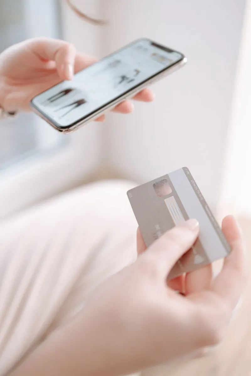 A bank card tapped on a smartphone for a contactless payment