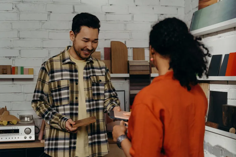 A shopkeeper taking payment from a customer with Nextepay